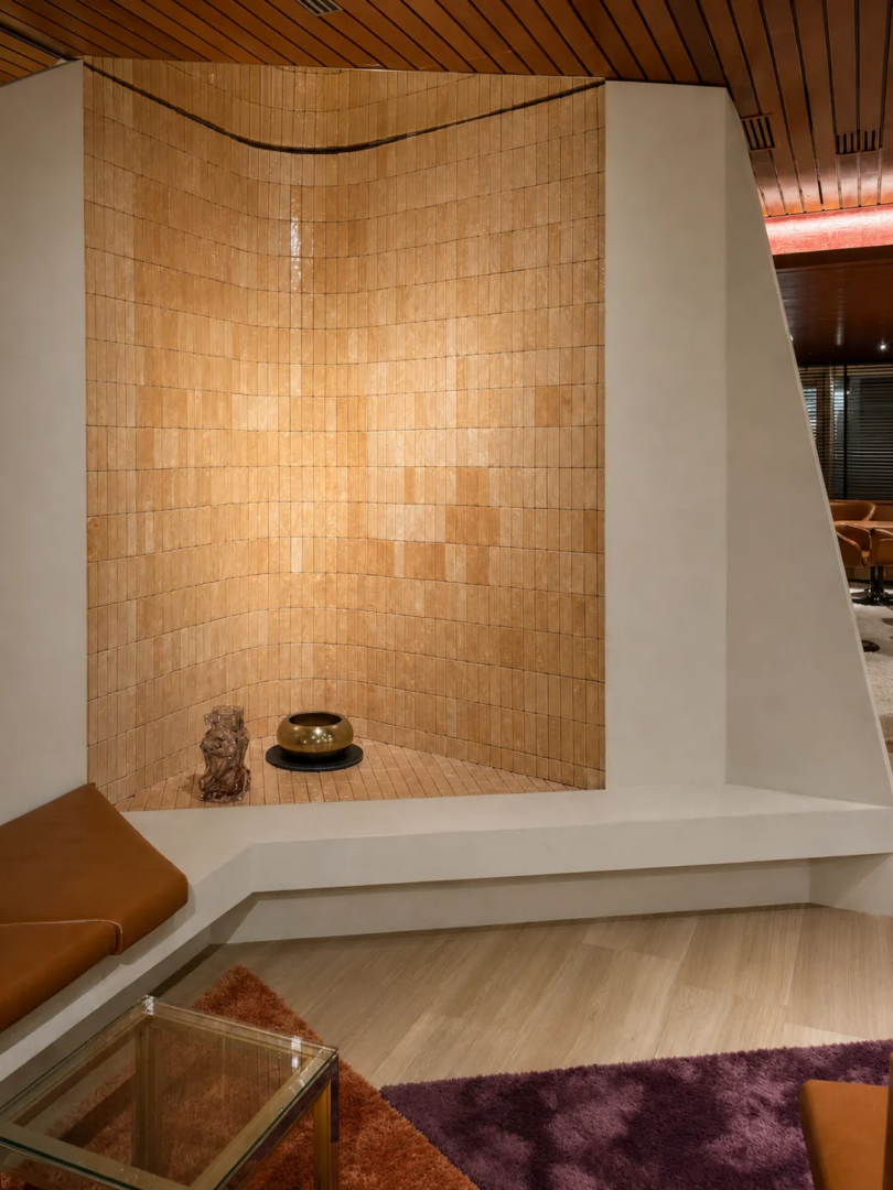 Ceramic surfaces and built-in seating within the layered interiors of Aurora