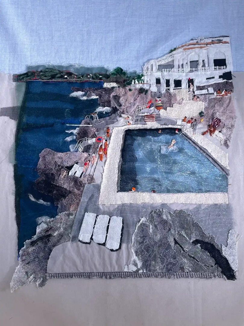 Sandrine Torredemer textile artwork made from upcycled fabric and thread, depicting a coastal swimming pool, rocky shoreline and white seaside architecture