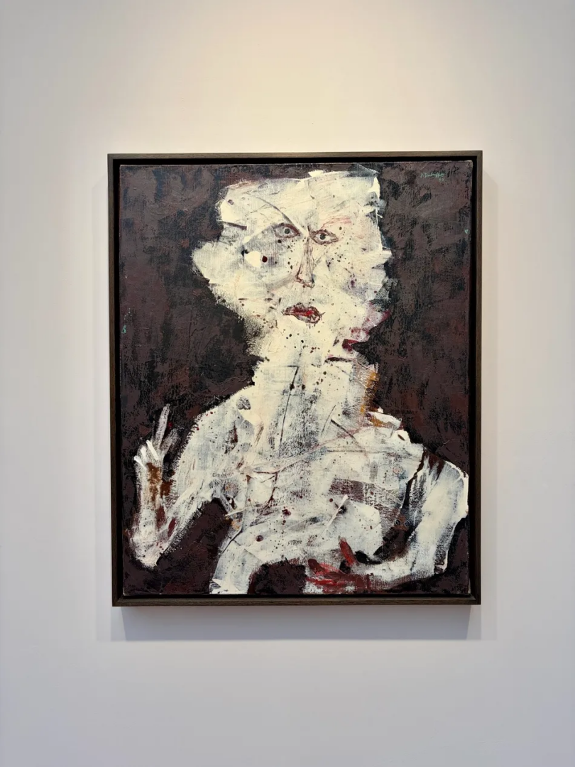 Expressive portrait by Jean Dubuffet showing a pale, roughly outlined human figure against a dark background, with scratched textures, red lips and a raised hand.