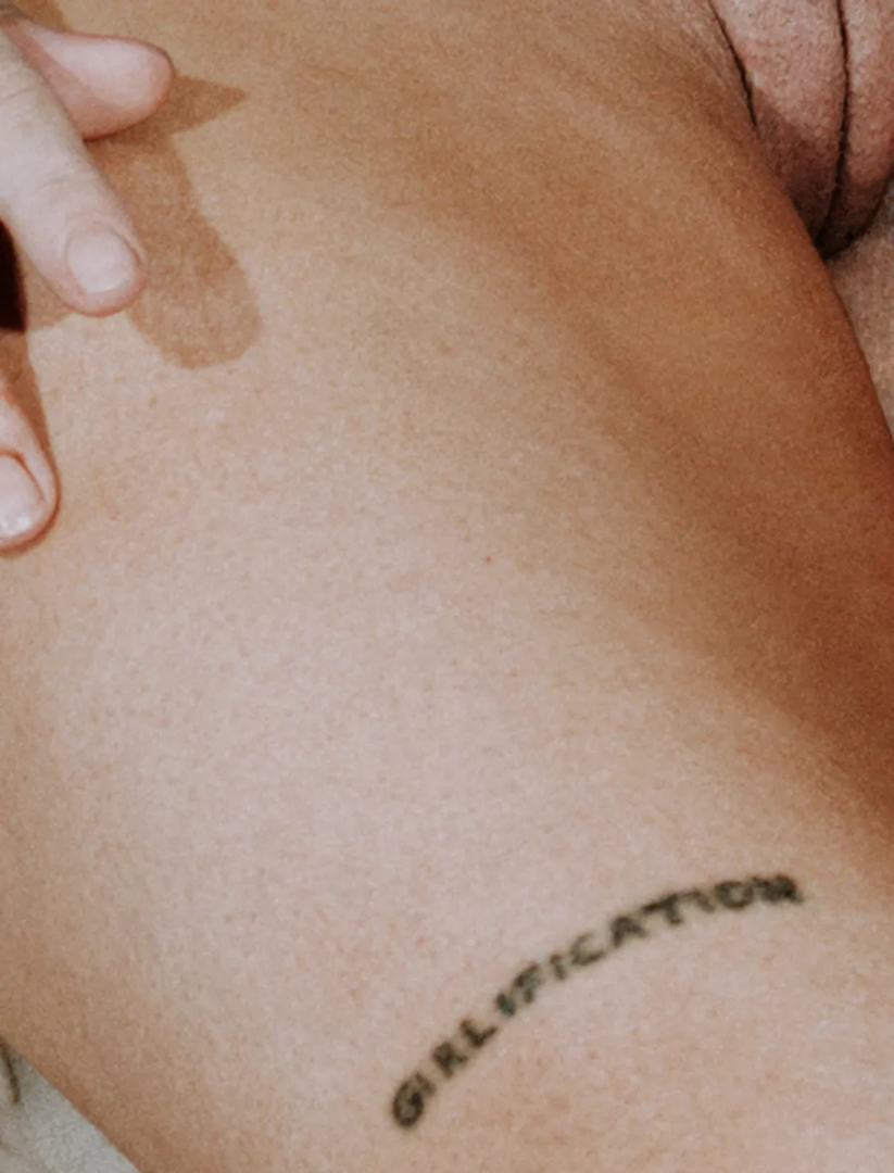 Close-up of Maja Malou Lyse’s hip and thigh, featuring a curved script tattoo, natural skin texture and a hand resting gently on the body, photographed by Lalo + Eva
