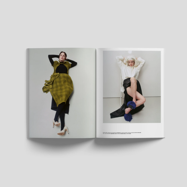 Lampoon SALIVA Issue 34 fashion editorial spread featuring two models in sculptural layered looks, including a green checked dress and a white hooded top with black skirt.