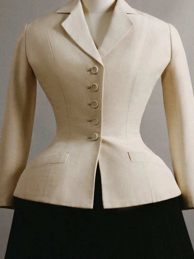 Celine atelier dress forms marked with tailoring guidelines, surrounded by white garments, fabric patterns and hanging prototypes.