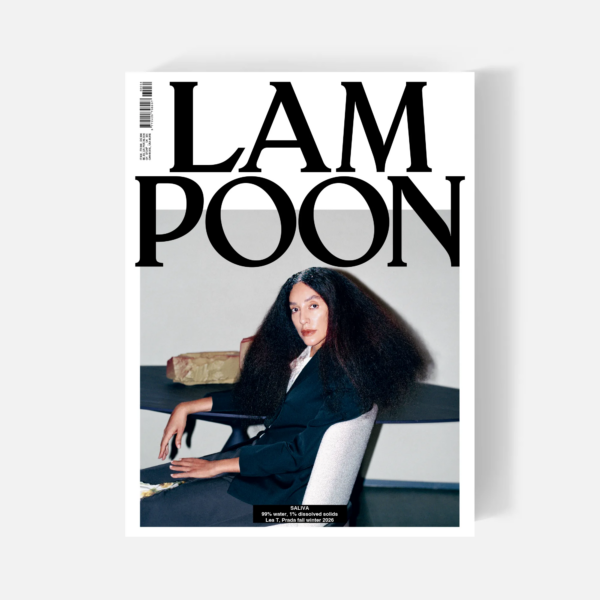 Lampoon SALIVA Issue 34 cover featuring a seated model in black Prada tailoring