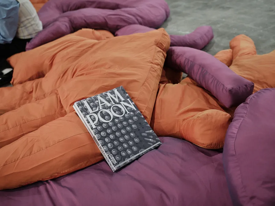 Lampoon magazine resting on a group of orange and purple padded fabric forms arranged across the floor.