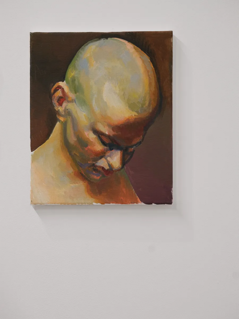 Painted portrait of a bald figure looking downward, with visible brushstrokes in yellow, green, orange and brown against a dark background.