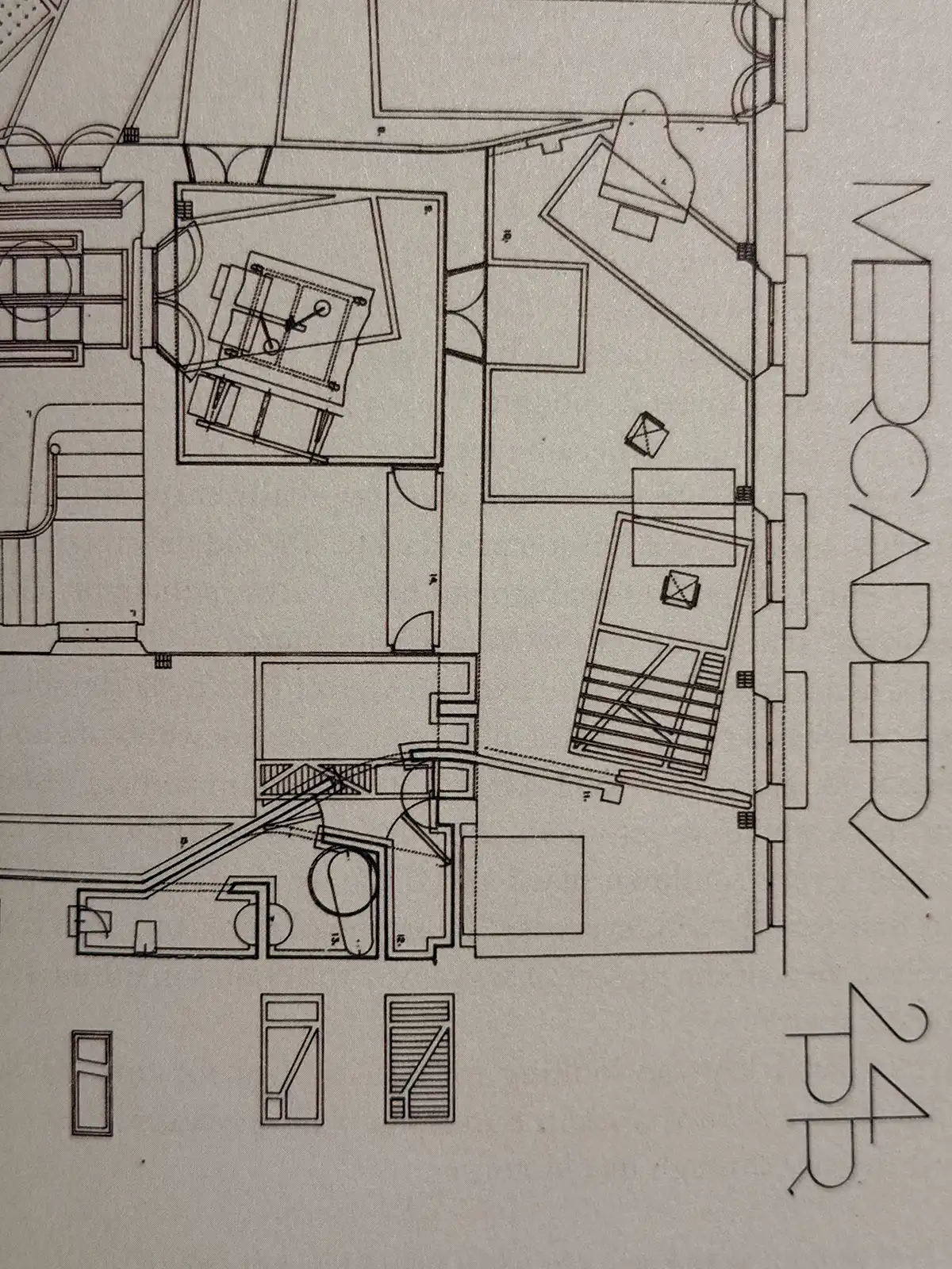 Black-and-white architectural floor plan showing room layouts, staircases, furniture arrangements and structural details, with the text “MECANEDA 24 BB” along the right side.