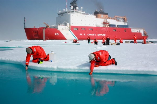 Sampling Melt Ponds. On July 10, 2011, Jens Ehn of Scripps Institution of Oceanography (left), and Christie Wood of Clark University (right), scooped water from melt ponds on sea ice in the Chukchi Sea. The water was later analyzed from the Healy's onboard science lab. The ICESCAPE mission, or "Impacts of Climate on Ecosystems and Chemistry of the Arctic Pacific Environment," is a NASA shipborne investigation to study how changing conditions in the Arctic affect the ocean's chemistry and ecosystems.