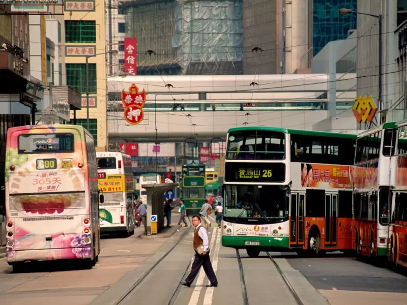 A man crossing tram lines on Hong Kong Island,Chris Stowers Hong Kong, China