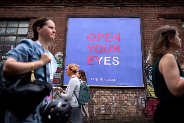 Lampoon, Berlin, Germany, Participants in front of a poster with the motto Open Your Eyes at the 2022 Re_publica 22, the fifteenth edition of the digital society festival,Stefan Boness,Panos Pictures