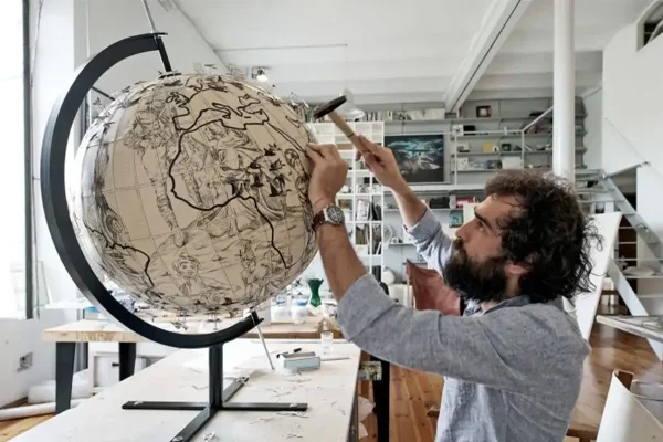 Lampoon. Pietro Ruffo working at one of his globe work series
