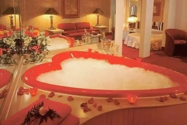 Room at Cove Haven Resort in the Poconos shows with heart-shaped bathtub by Morris Wilkins