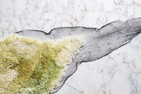 Lampoon, SEA ME, is a rug made of sea algae yarn, knotted by hand in an old fishing net.Image Femke Poort